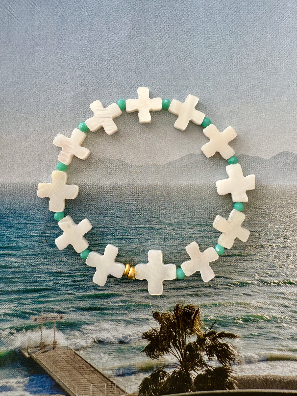 Handcrafted ocean-inspired St Jean Bracelet featuring mother of pearl and sea green beads on elastic, perfect for summer stacking.