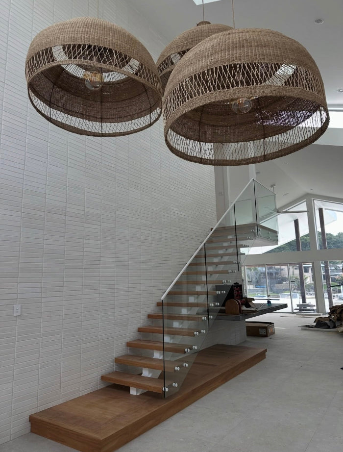Modern interior with wicker pendant lights over a staircase