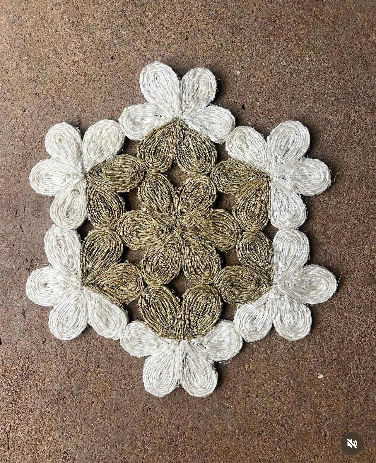 Handwoven floral placemat in neutral tones, inspired by nature, perfect for dining or decorative use.