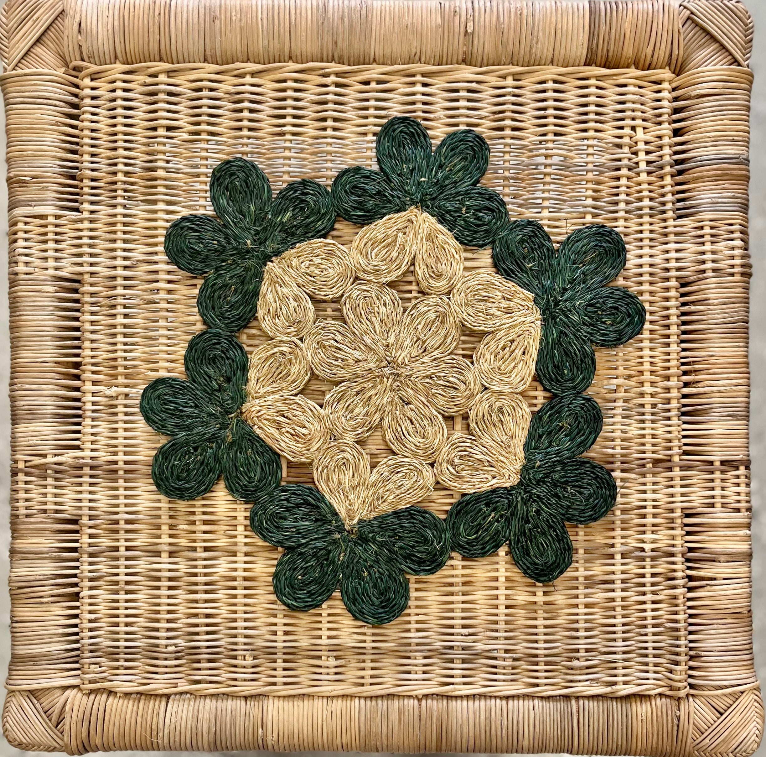 Handwoven floral placemat featuring intricate green and natural tones, perfect for dining tables or beach picnics.