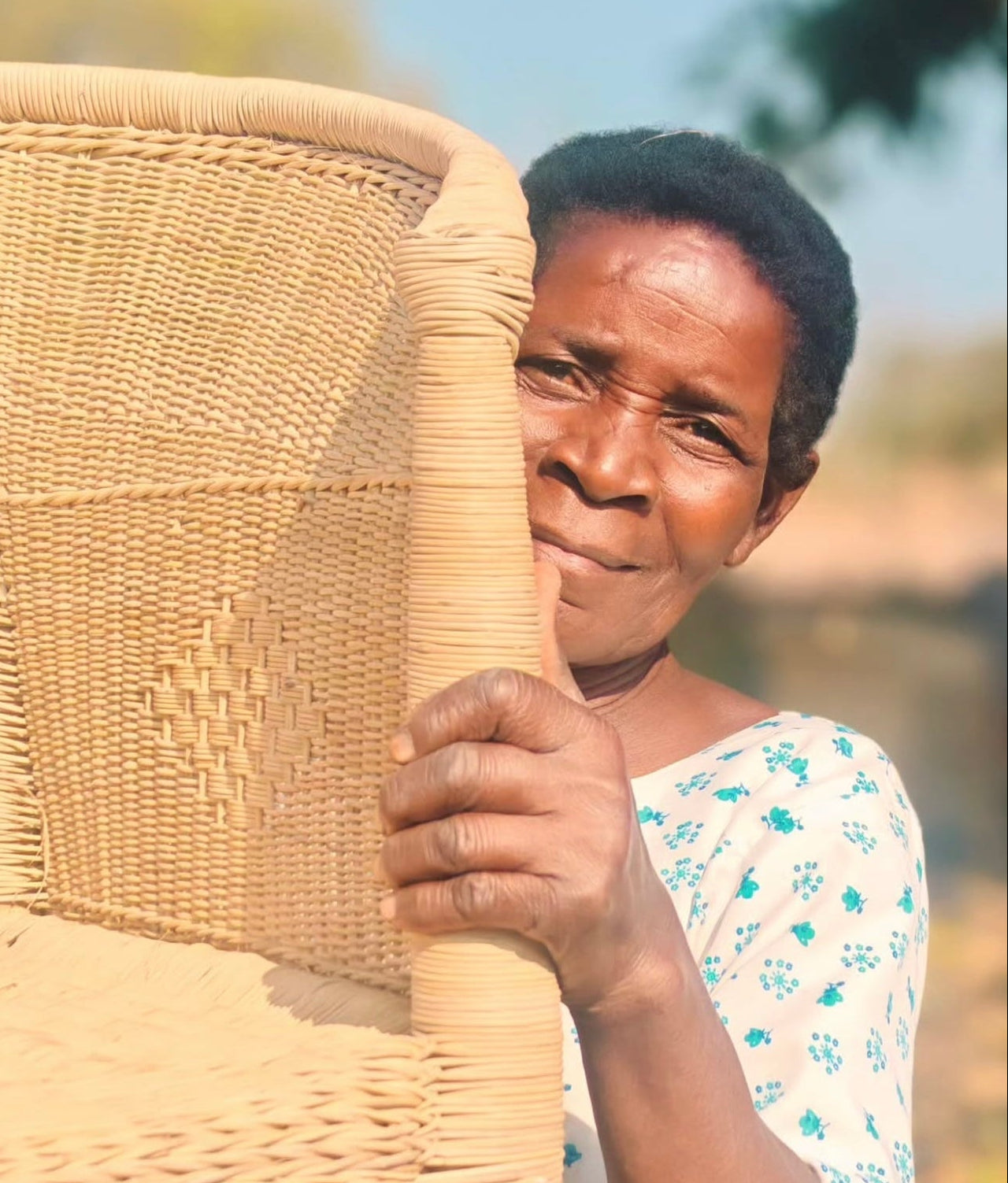 Malawi artisan showing her closed weave Malawi chair