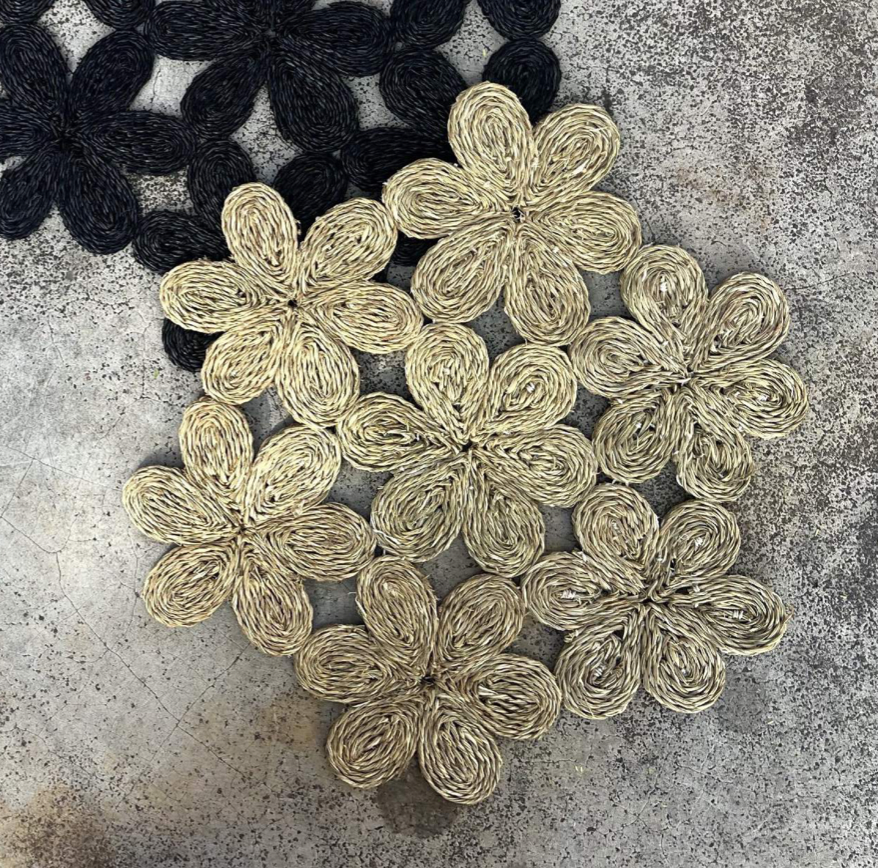 Handwoven floral inspired placemats in natural tones, perfect for dining tables and beach picnics.