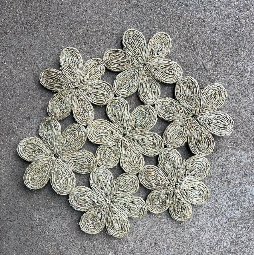 Handwoven floral-inspired placemat, featuring intricate flower designs, perfect for dining tables or beach picnics.