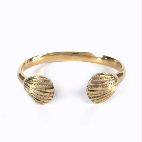 Gold bracelet with shell-like ends on a white background