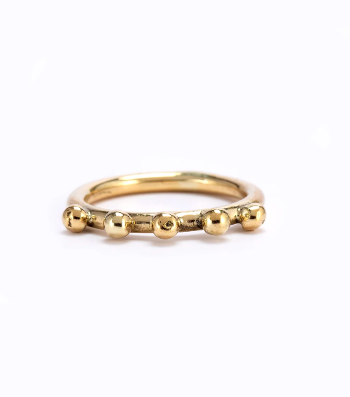 Gold beaded ring on a white background
