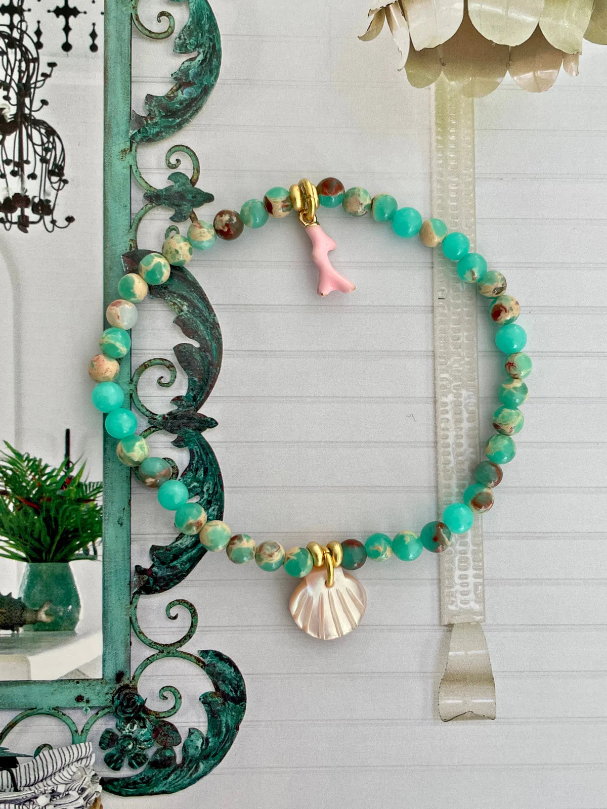Handcrafted ocean inspired jewelry featuring pink and sea green Jasper beads with coral and scallop shell charms.