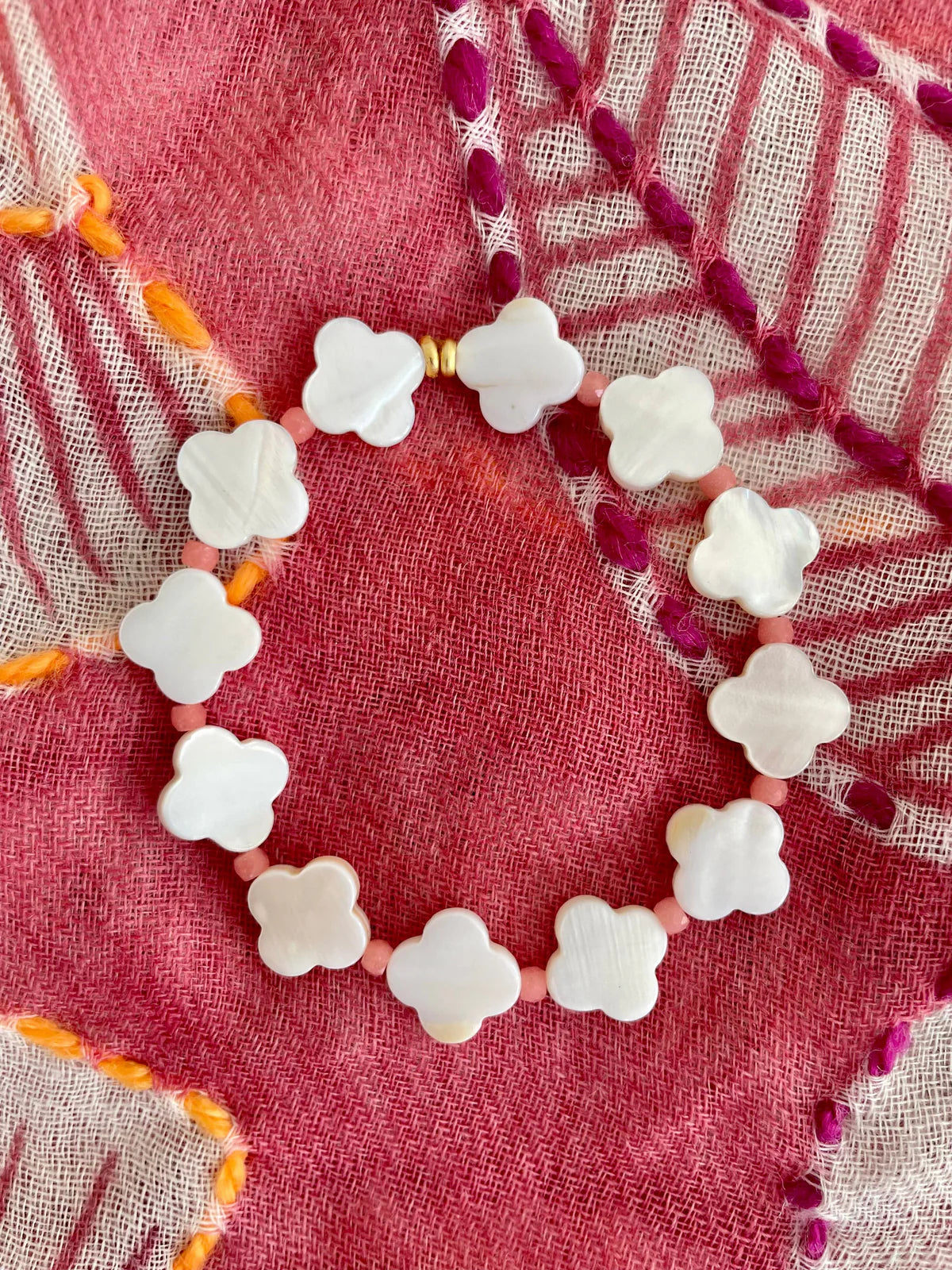 Handcrafted ocean-inspired jewelry, Porto Palo Bracelet with mother of pearl clover beads and coral accents.