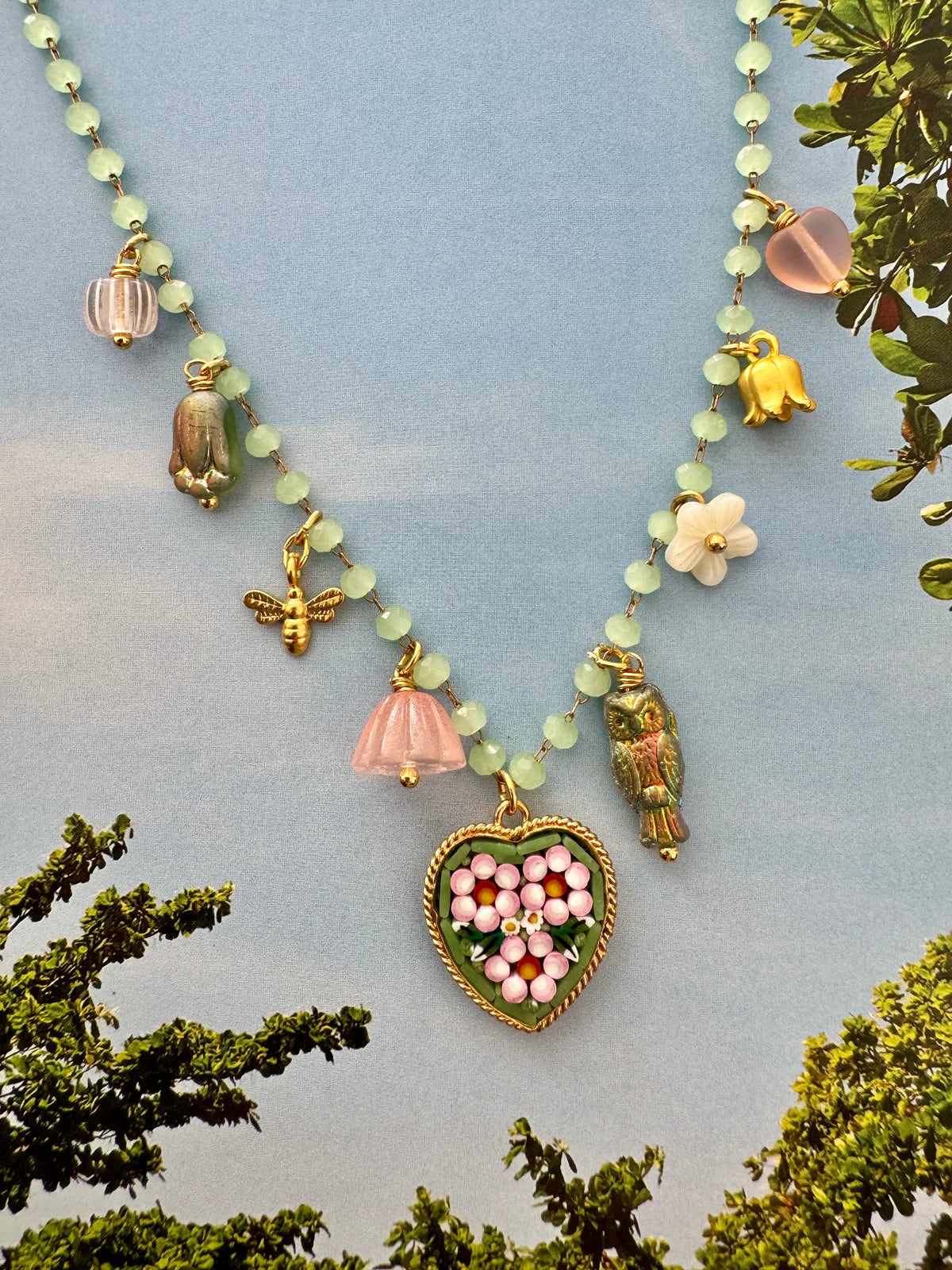 Handcrafted Florian Heart Necklace featuring micro mosaic pendant and ocean-inspired charms in pink and green colors.