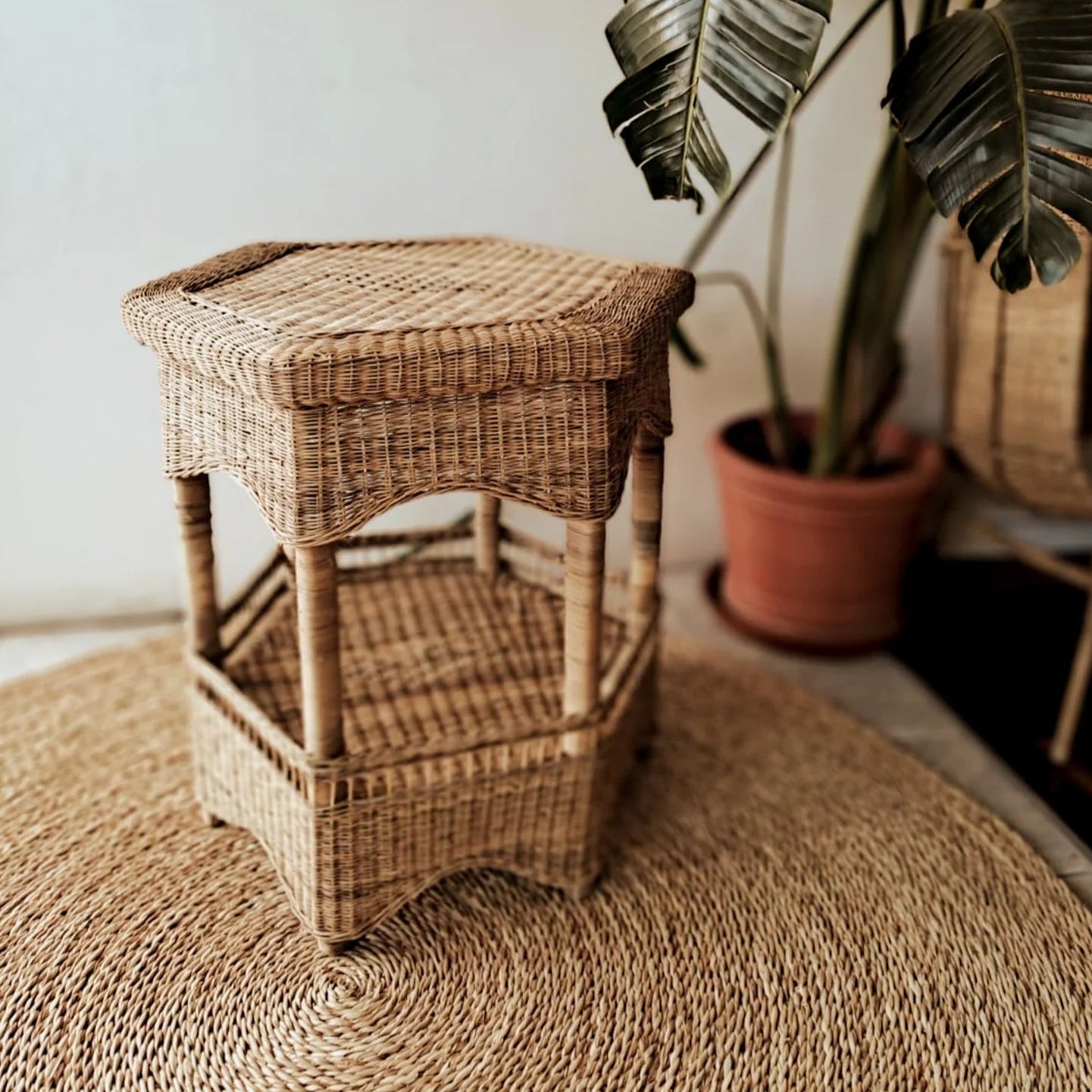 Handwoven rattan hexagon side table ideal for beach picnics, featuring woven cane basket design and rustic charm.