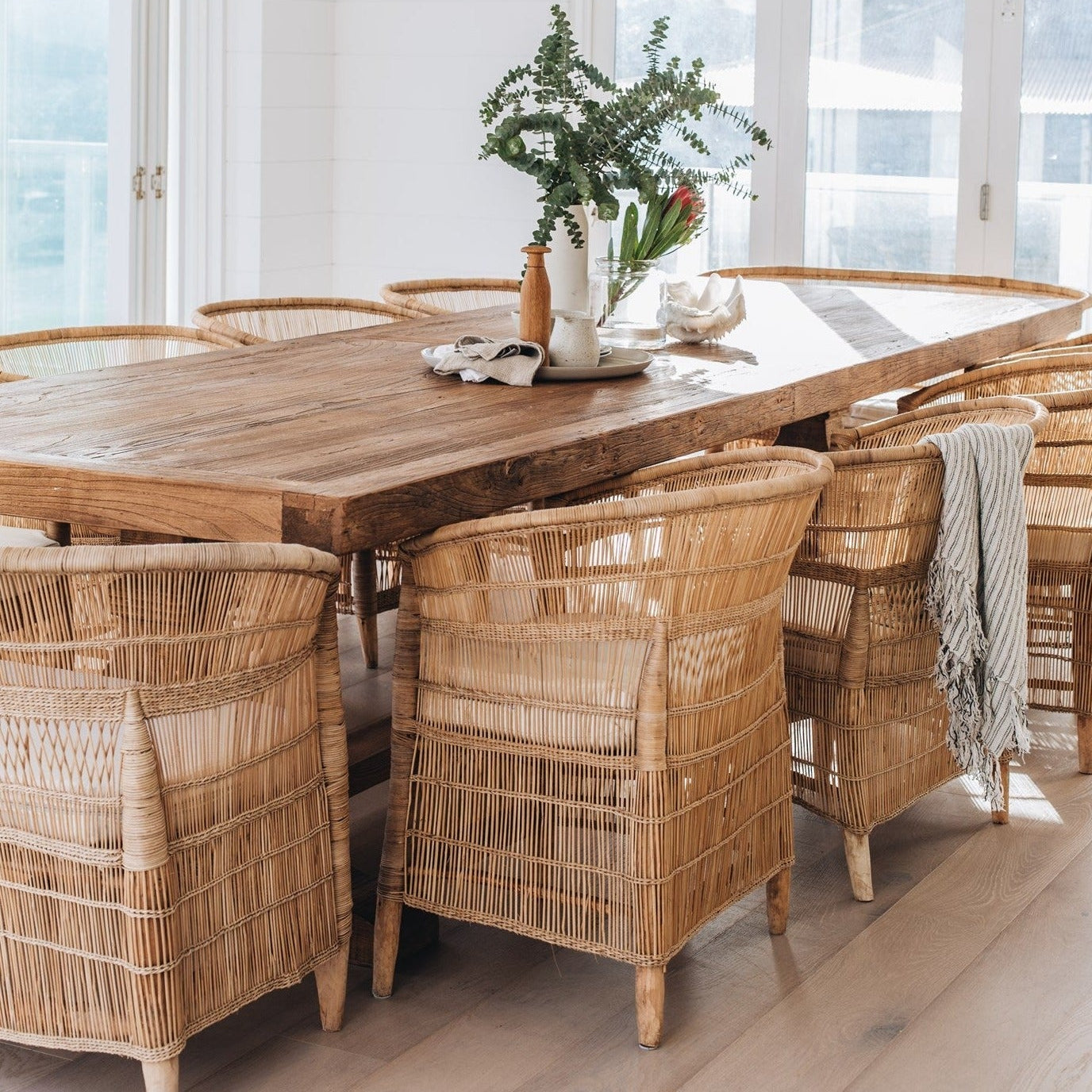 coastal dining scene with malawi cane chairs