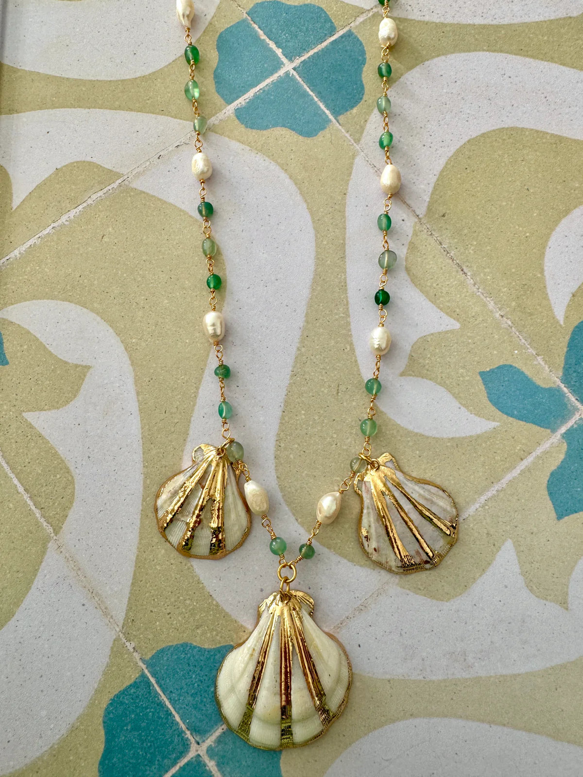 Handcrafted ocean-inspired Sapore di Mare necklace with green jade, pearls, and gold electroplated scallop shells.