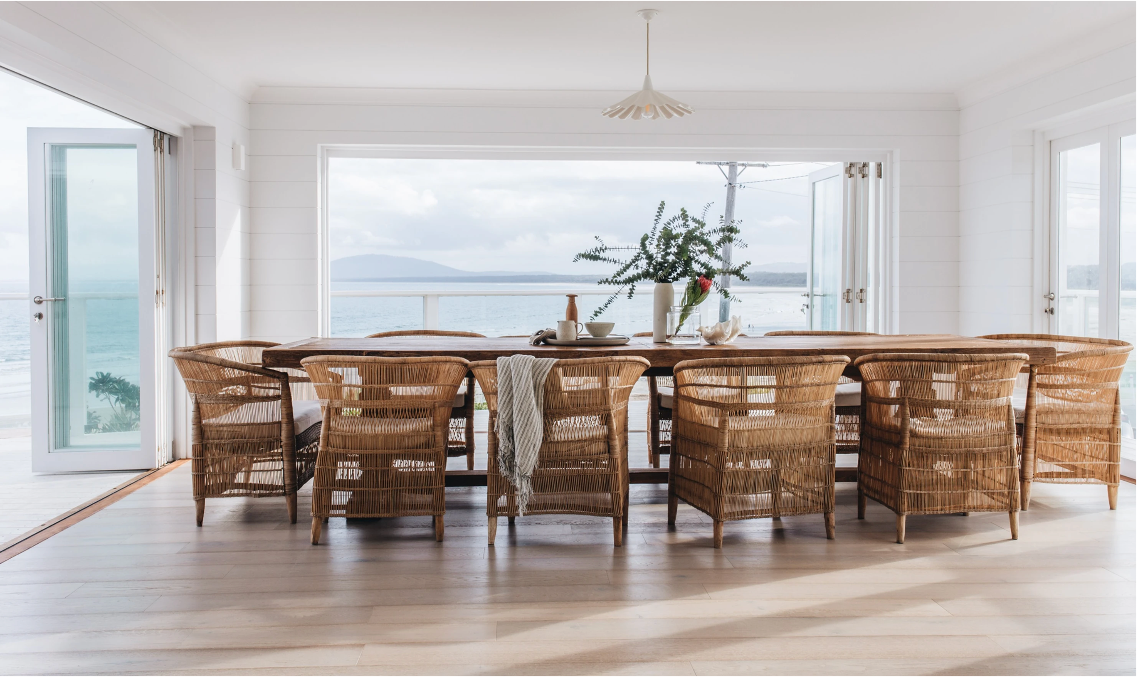 Malawi chairs around a large table with sea views